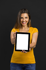 Image showing Woman holding and showing a tablet