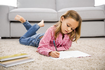 Image showing Little girl making homework