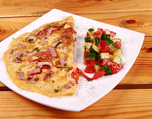 Image showing Omelet with prosciutto ham and rocket salad.