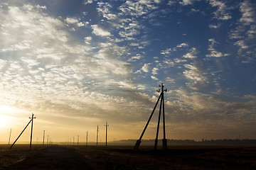 Image showing power poles in the field