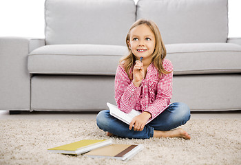 Image showing Little girl making homework