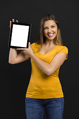 Image showing Woman holding and showing a tablet