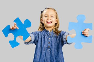 Image showing Girl holding a puzzle