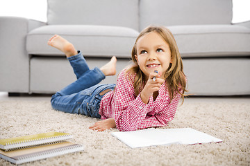 Image showing Little girl making homework