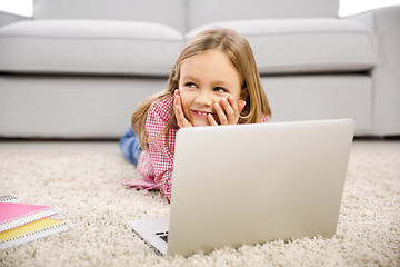 Image showing Little girl working with a laptop