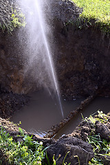 Image showing The water jet in the form of leakage in the damaged metal pipe at the production site