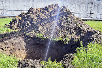 Image showing The water jet in the form of leakage in the damaged metal pipe at the production site