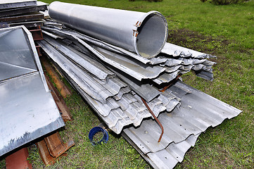 Image showing Metal parts are dismantled structures stored in the soil on the 