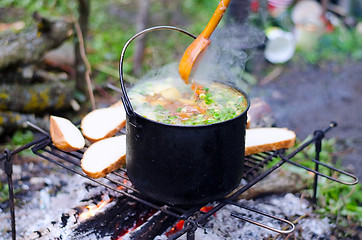 Image showing The cooking of soup on the fire