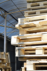 Image showing Waste wood from pallets stacked in the storage room