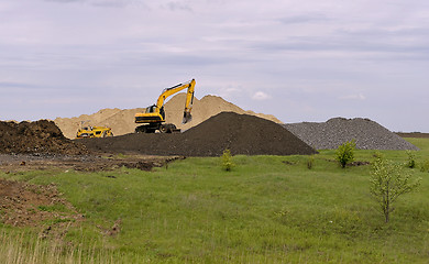 Image showing  Yellow excavator working digging in sand quarry