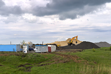 Image showing  Yellow excavator working digging in sand quarry