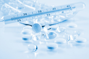 Image showing Pills and thermometer in blue tone