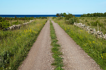 Image showing Gravel road straight to the sea