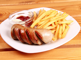 Image showing grilled sausages with French fries and ketchup