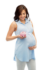 Image showing happy pregnant woman with piggybank