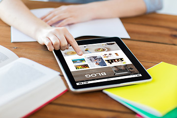 Image showing close up of student with tablet pc and notebook