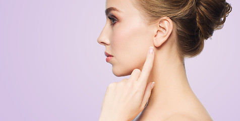 Image showing beautiful woman pointing finger to her ear