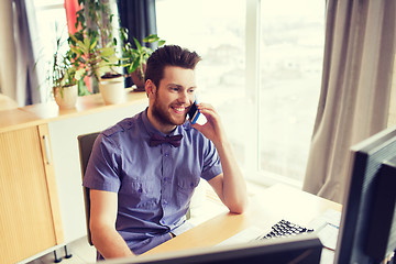 Image showing happy creative male worker calling on smarphone