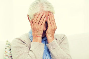 Image showing senior woman suffering from headache or grief