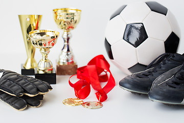 Image showing close up of football, boots, gloves, cup and medal