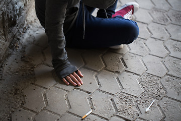 Image showing close up of addict woman and drug syringes
