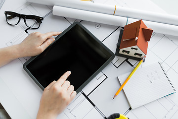 Image showing close up of hand with blueprint and tablet pc