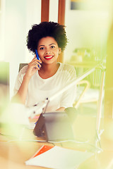 Image showing businesswoman calling on smartphone at office