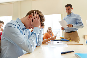 Image showing teacher giving test results to group of students