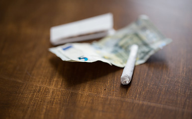 Image showing close up of marijuana joint and money