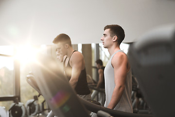 Image showing group of men exercising on treadmill in gym