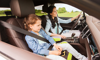 Image showing happy woman with little child driving in car