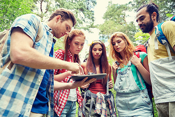 Image showing happy friends with backpacks and tablet pc hiking