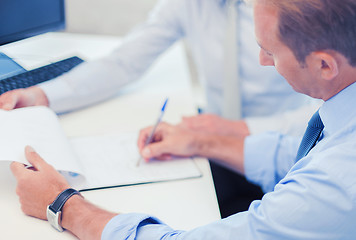 Image showing businessmen with notebook on meeting