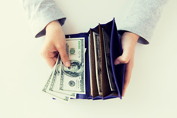 Image showing close up of woman hands with wallet and money