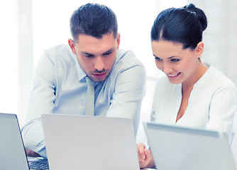 Image showing group of people working with laptops in office