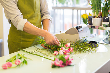 Image showing close up of man making bunch at flower shop