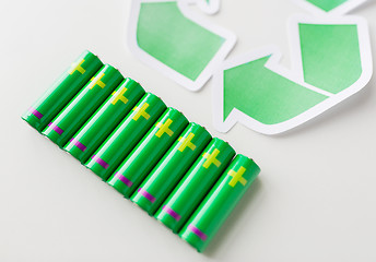 Image showing close up of batteries and green recycling symbol