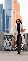 Image showing citizen with a wooden case and books in the city