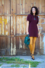 Image showing beautiful middle-aged brunette in burgundy dress