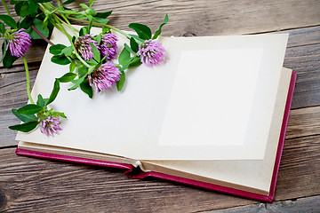 Image showing photo album and clover flowers