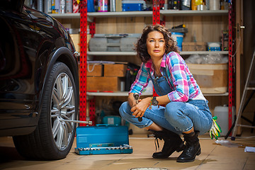 Image showing smiling woman mechanic in overalls