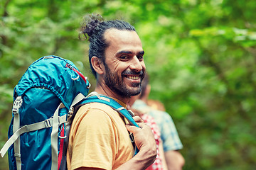 Image showing group of smiling friends with backpacks hiking