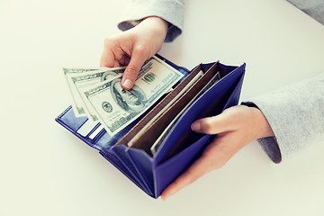 Image showing close up of woman hands with wallet and money