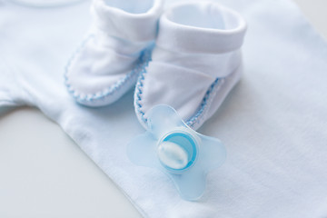 Image showing close up of soother and baby clothes for newborn