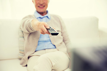 Image showing close up of happy senior woman watching tv at home