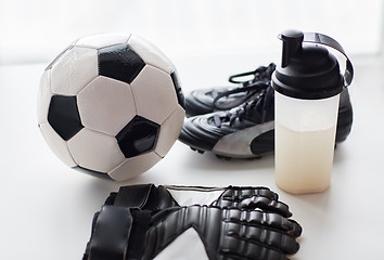 Image showing close up of football boots, gloves and bottle