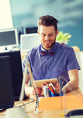 Image showing happy creative male office worker with tablet pc