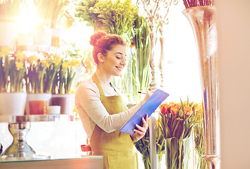 Image showing florist woman with clipboard at flower shop