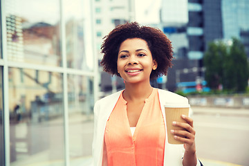 Image showing happy african businesswoman with coffee in city